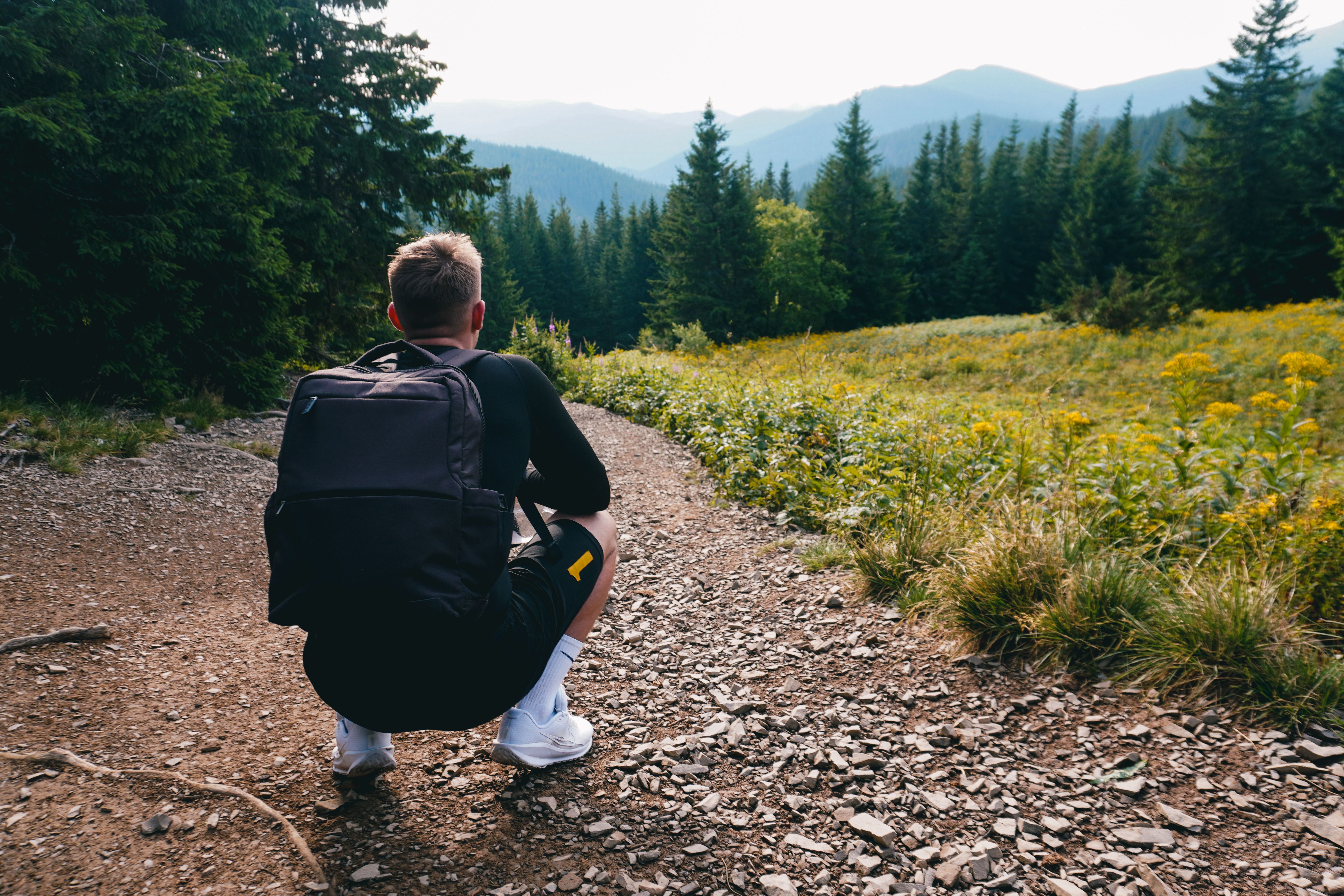 Hiker admiring a scenic mountain view on a sunny day