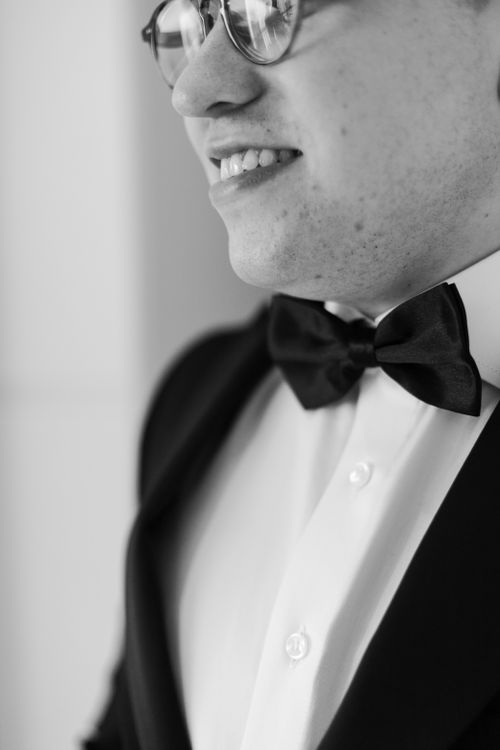 Free Elegant close-up of a groom in a tuxedo and bow tie in black and white. Stock Photo