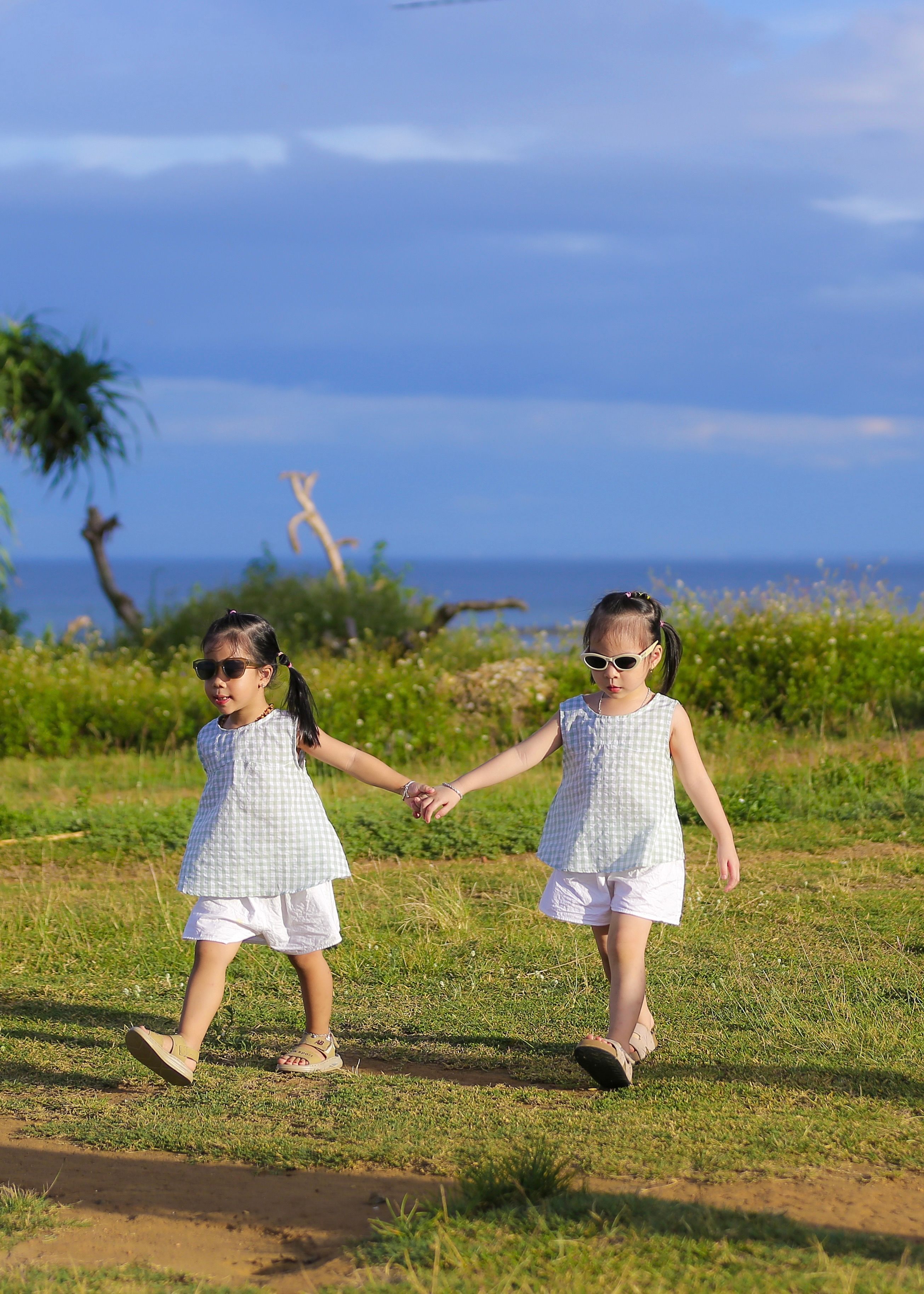 Two Young Girls Walking Hand in Hand Outdoors · Free Stock Photo