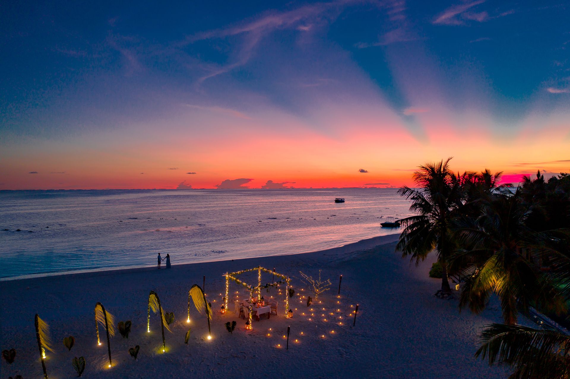 A serene beach at sunset with a romantic gazebo and palm trees. Perfect for a getaway.