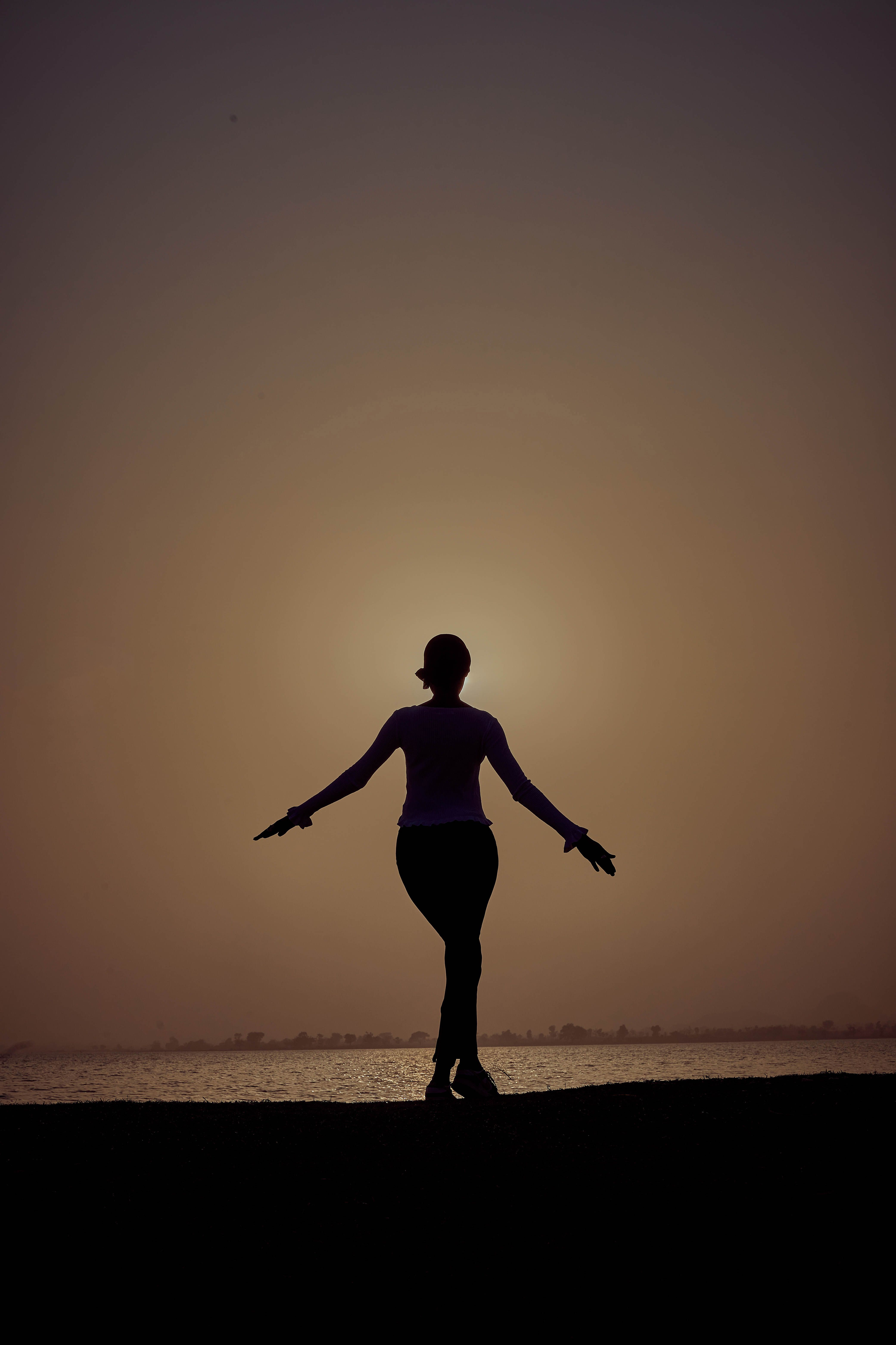 Silhouette of Woman in Yoga Pose at Sunset · Free Stock Photo