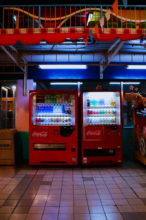 Free Vibrant night view of red Coca-Cola vending machines in Taiwan, featuring glowing lights and colorful surroundings. Stock Photo