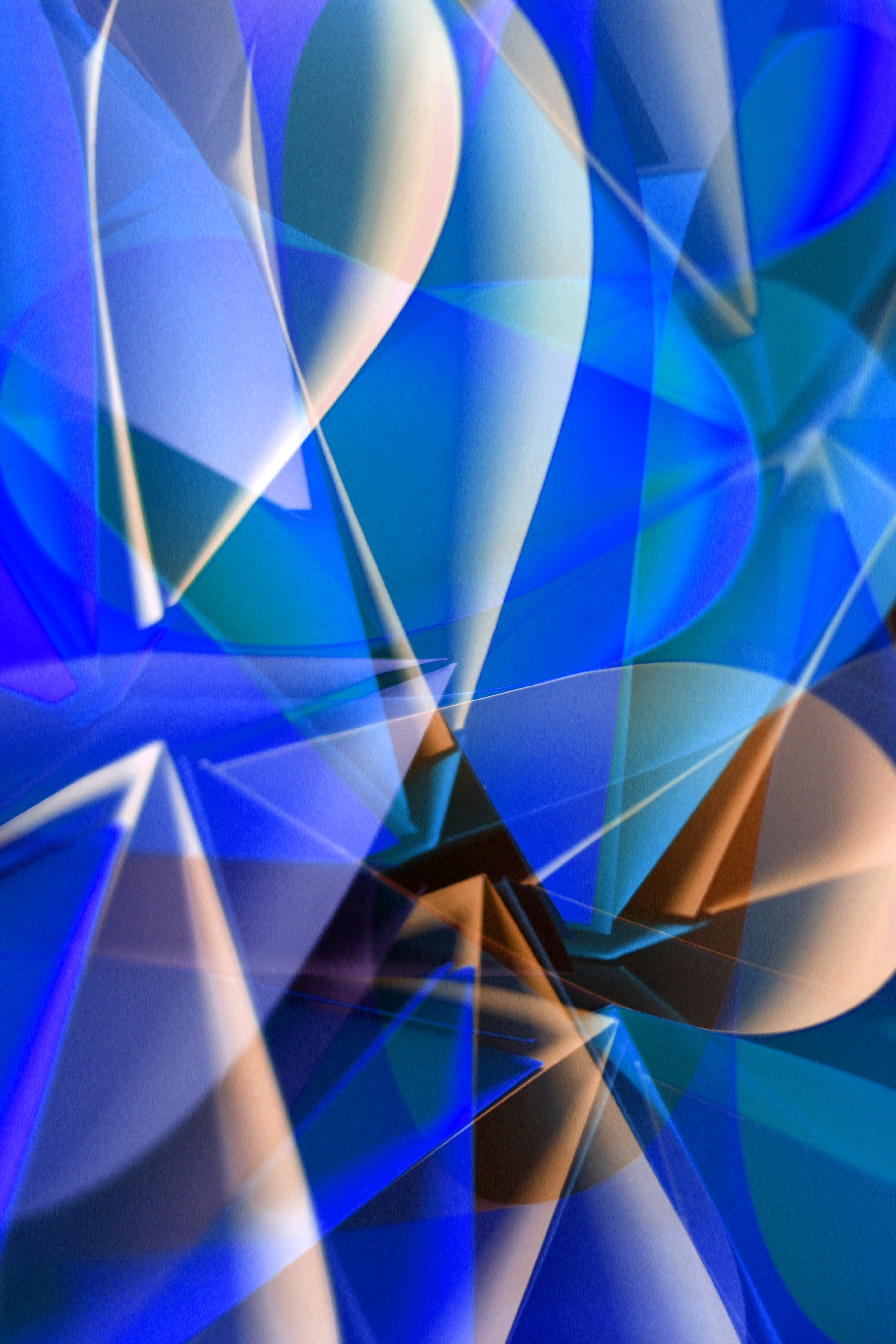 Abstract image featuring dynamic blue and beige geometric shapes, creating a sense of movement and depth.