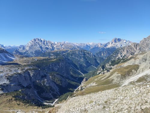 Free Stunning panoramic view of the Dolomites mountain range in Italy under a clear blue sky. Stock Photo