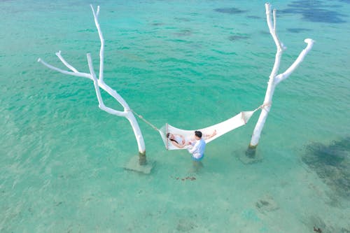 Free Person Lying on White Hammock Stock Photo