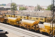 Bright Yellow Maintenance Trains in Urban Rail Yard