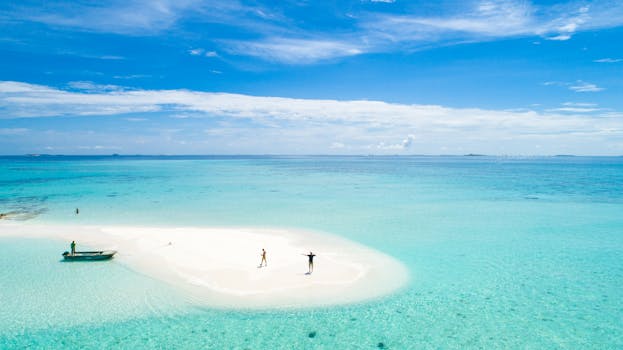 Stunning aerial view of a secluded tropical island with turquoise waters, perfect for a dream vacation.