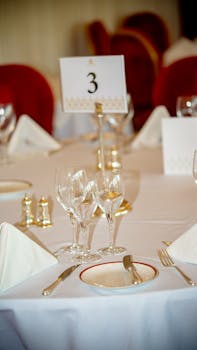 Classy table setting with neatly arranged dinnerware and glassware for a formal event.