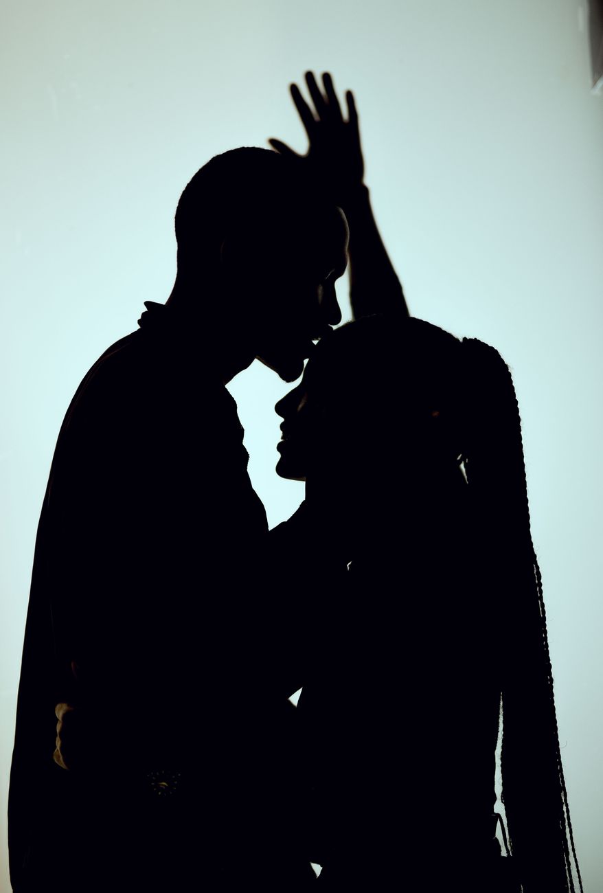 Artistic silhouette of a couple embracing, highlighting romantic and tender moments.