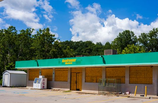 Image of an abandoned Roadrunner Markets store with boarded windows.