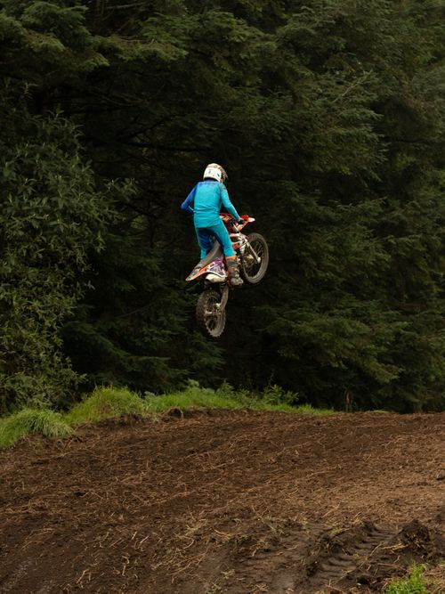 Free Thrilling motocross rider performing a jump in La Marquesa forest, Mexico. Stock Photo
