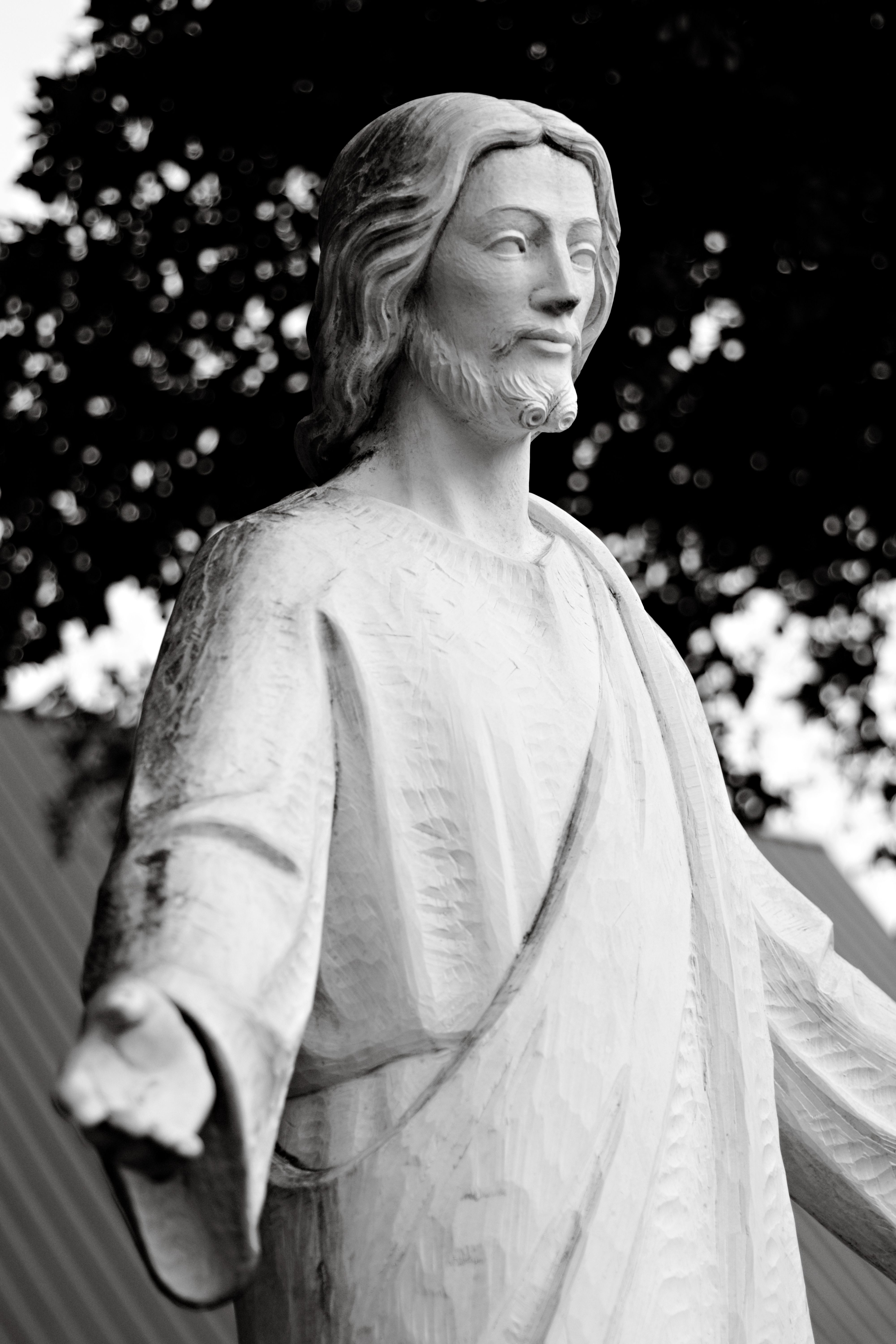 Black and white photo of a Jesus statue in outdoor setting, South Miami.