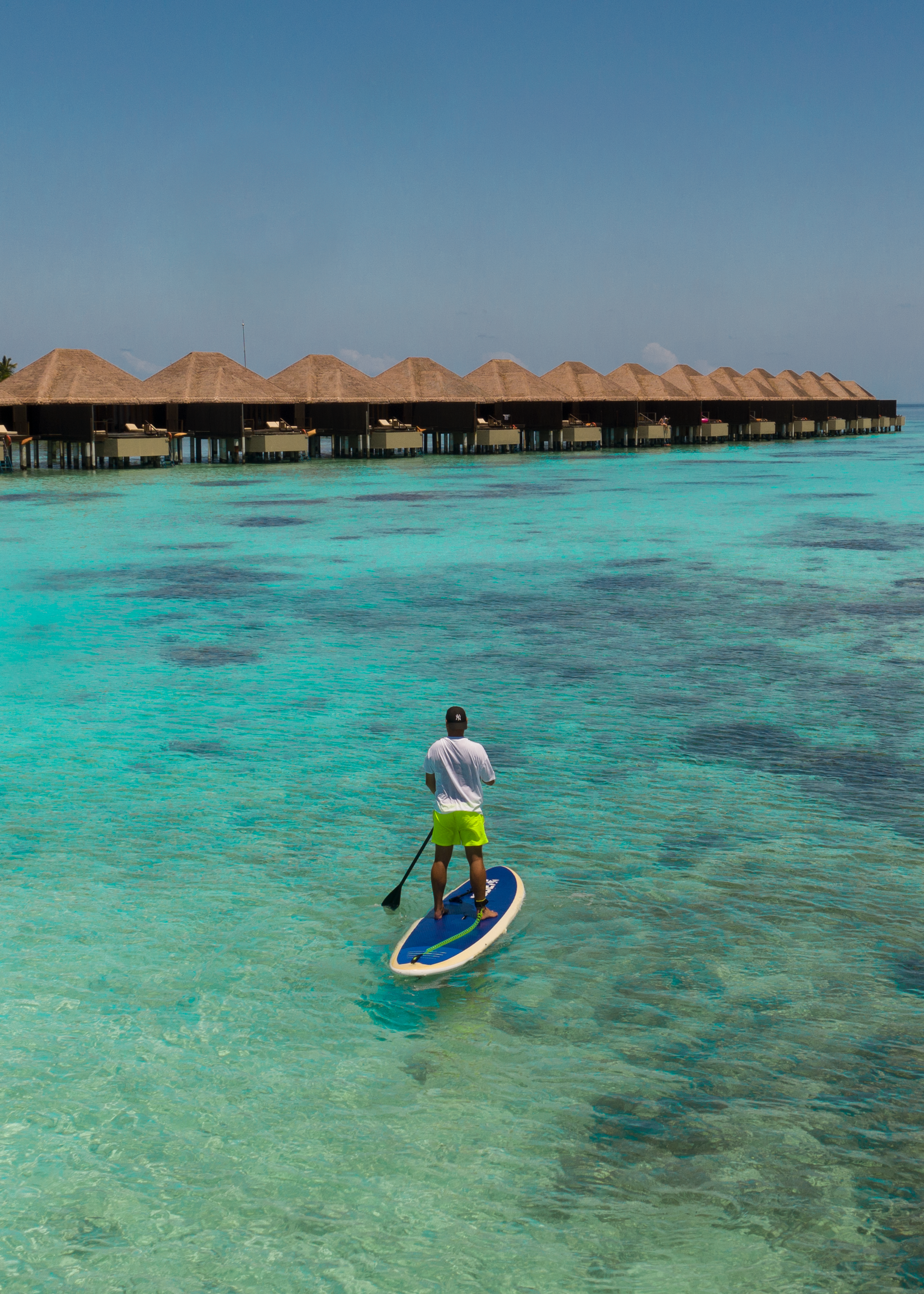paddleboarding adventure by overwater bungalows