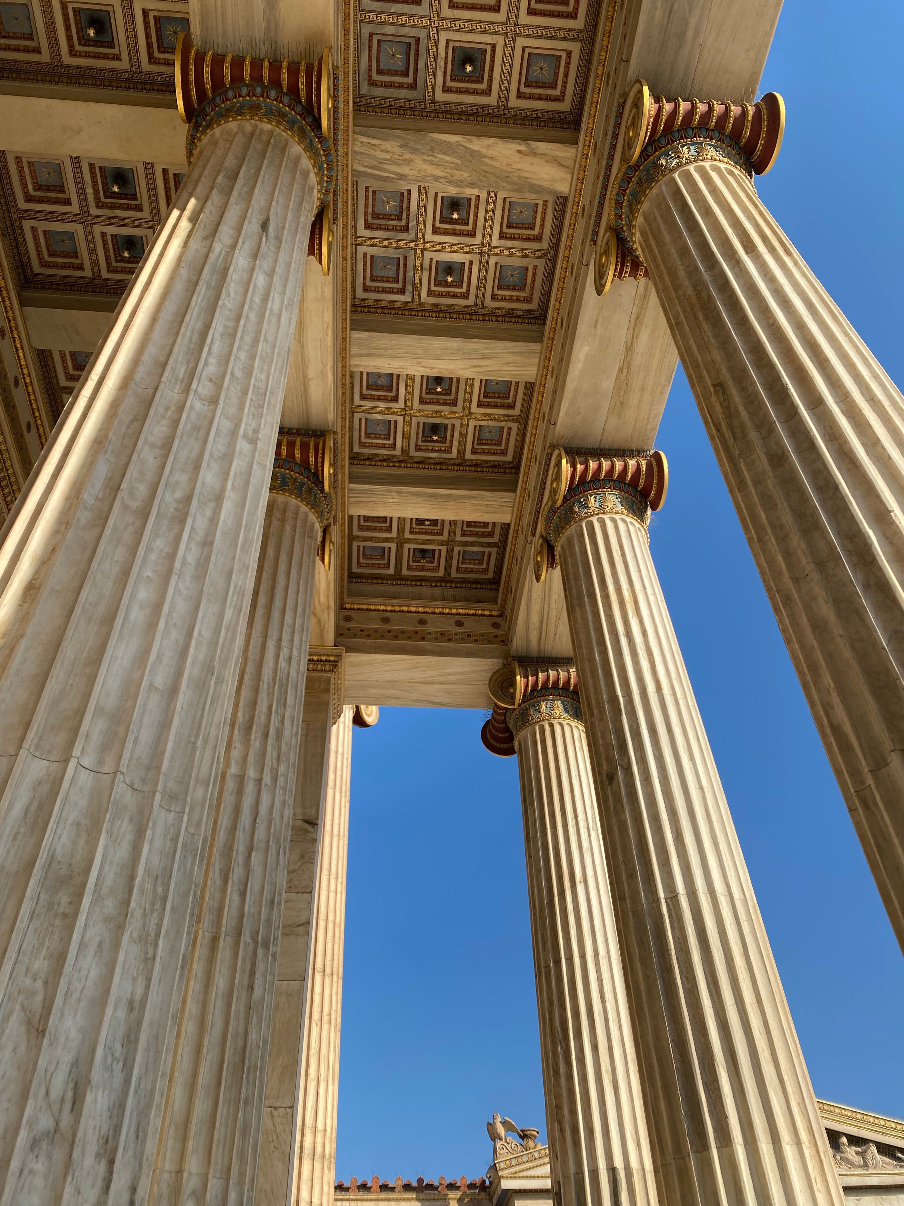 Majestic Neoclassical Columns under Clear Blue Sky · Free Stock Photo