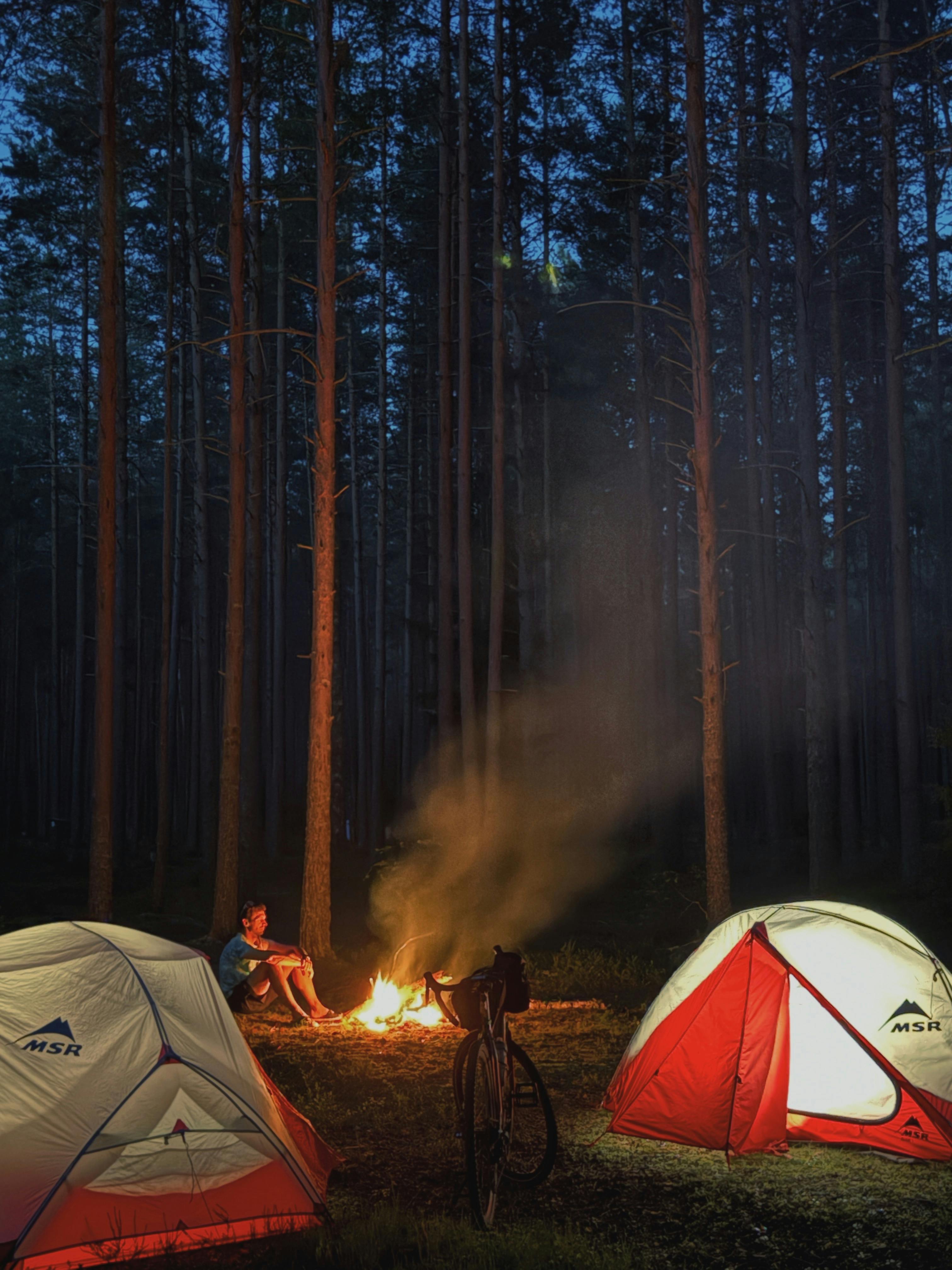 Young family sitting around a campfire at a campground