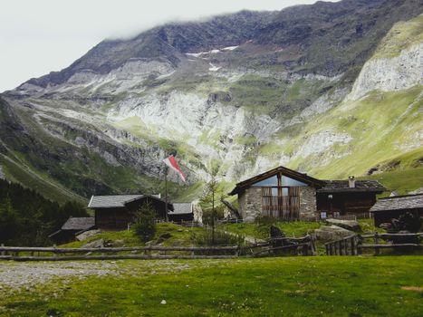Charming rural farmhouse set against majestic Trentino-Alto Adige mountain landscape.