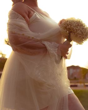 Captivating moment of a bride holding a bouquet during a stunning sunset in Osogbo, Nigeria.