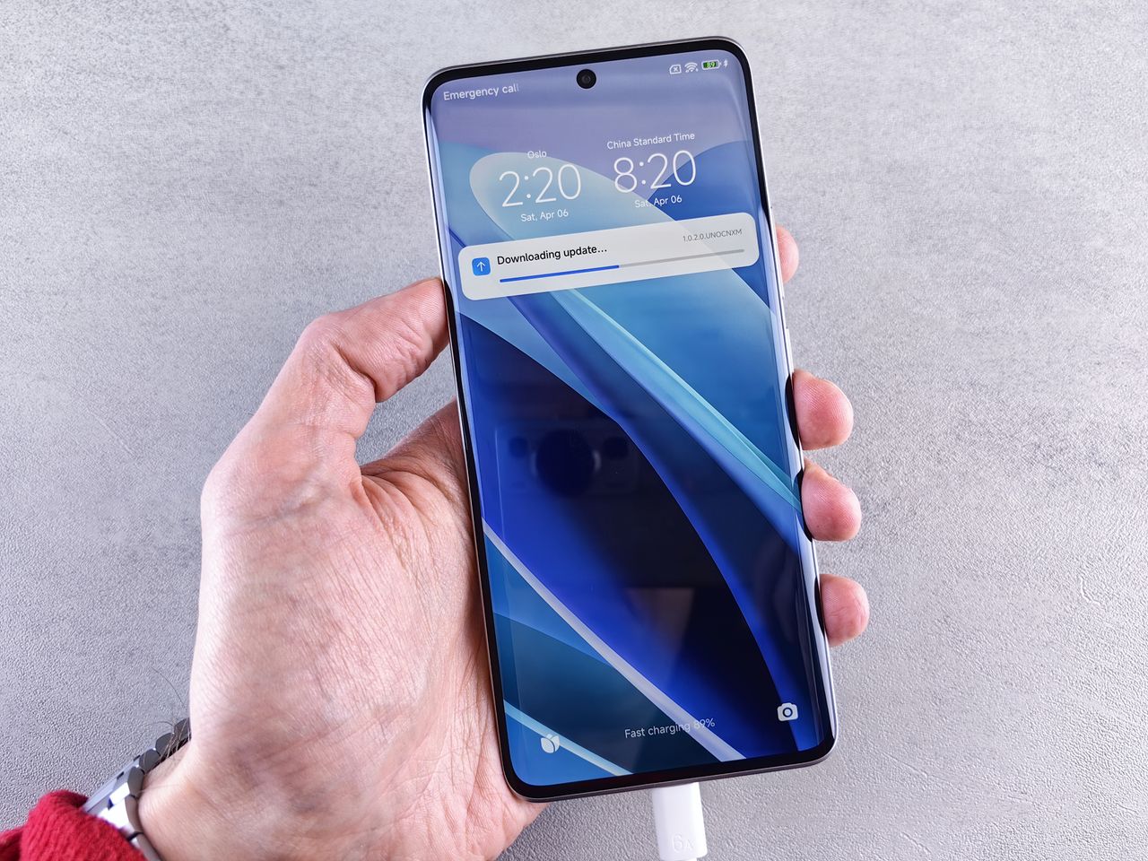 close up of a hand holding a smartphone with a downloading update noti