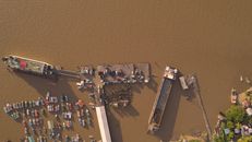 Aerial shot of Parika dock in Guyana showing boats and piers on the Essequibo River.