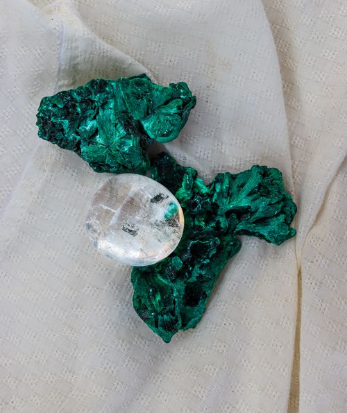 Free Aesthetic display of malachite with quartz on white textured fabric background. Stock Photo