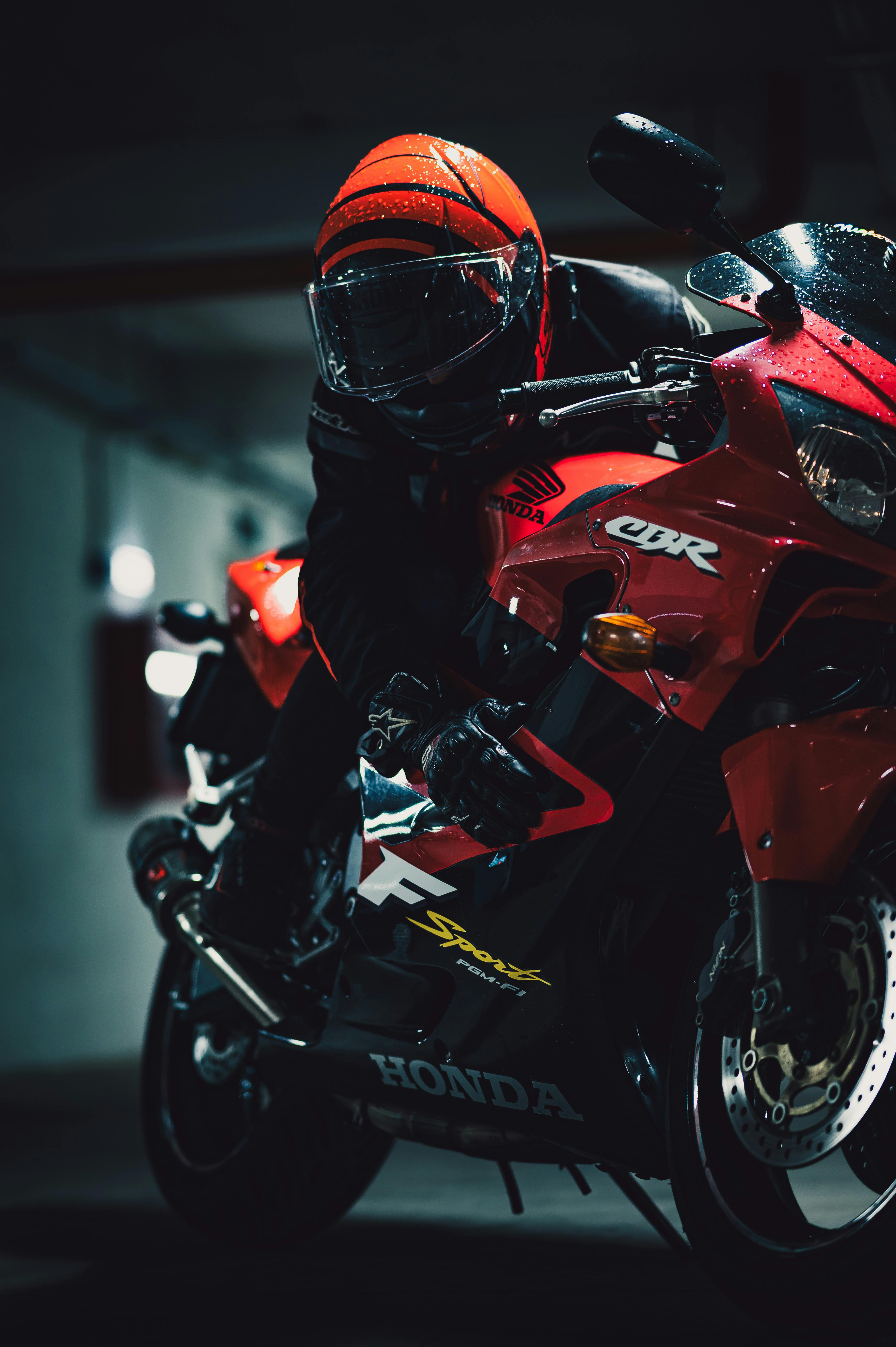 Close-up of a motorcycle rider in action during nighttime.