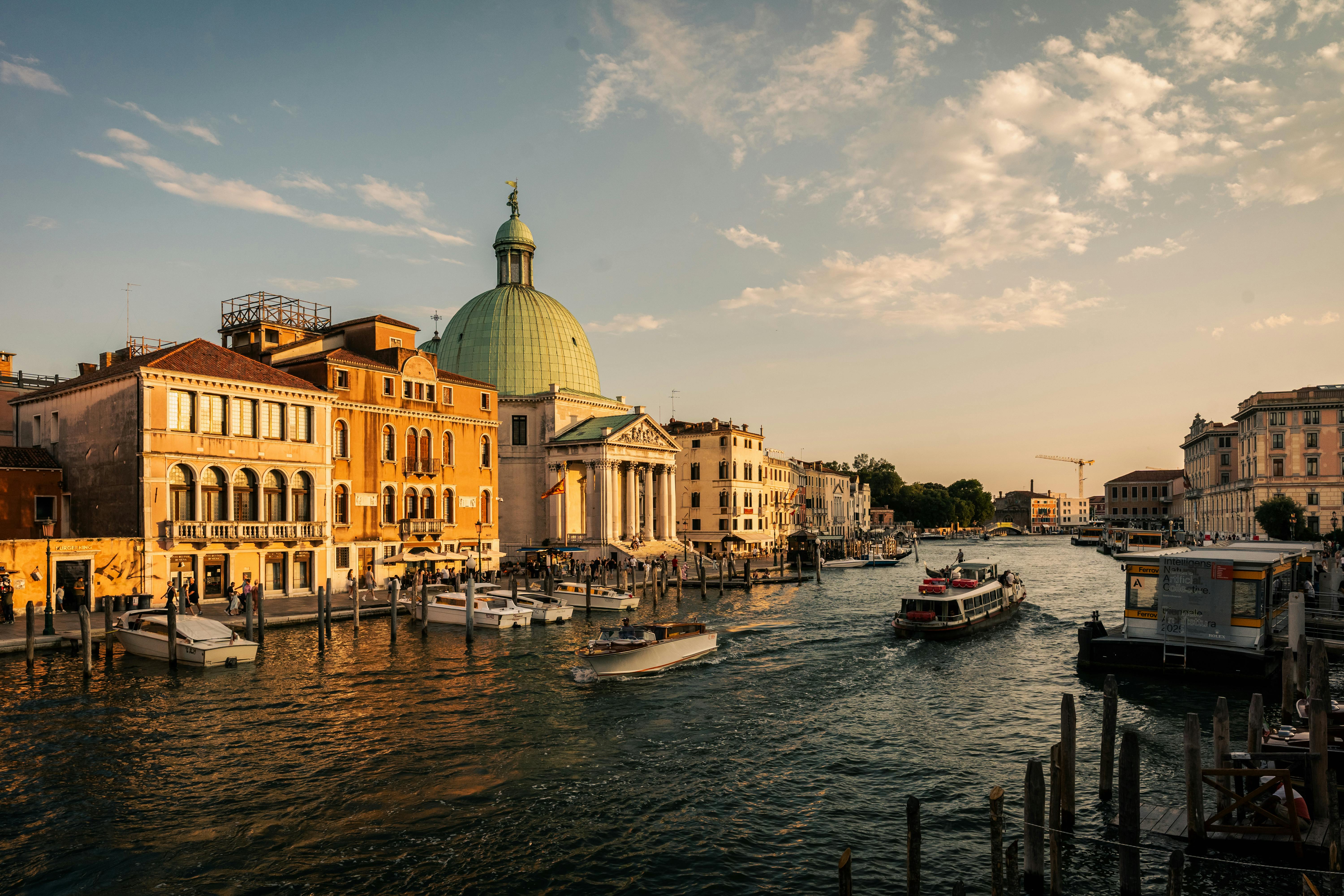 Explore the beauty of Venice's Grand Canal with its historic architecture and vibrant waterways at sunset.