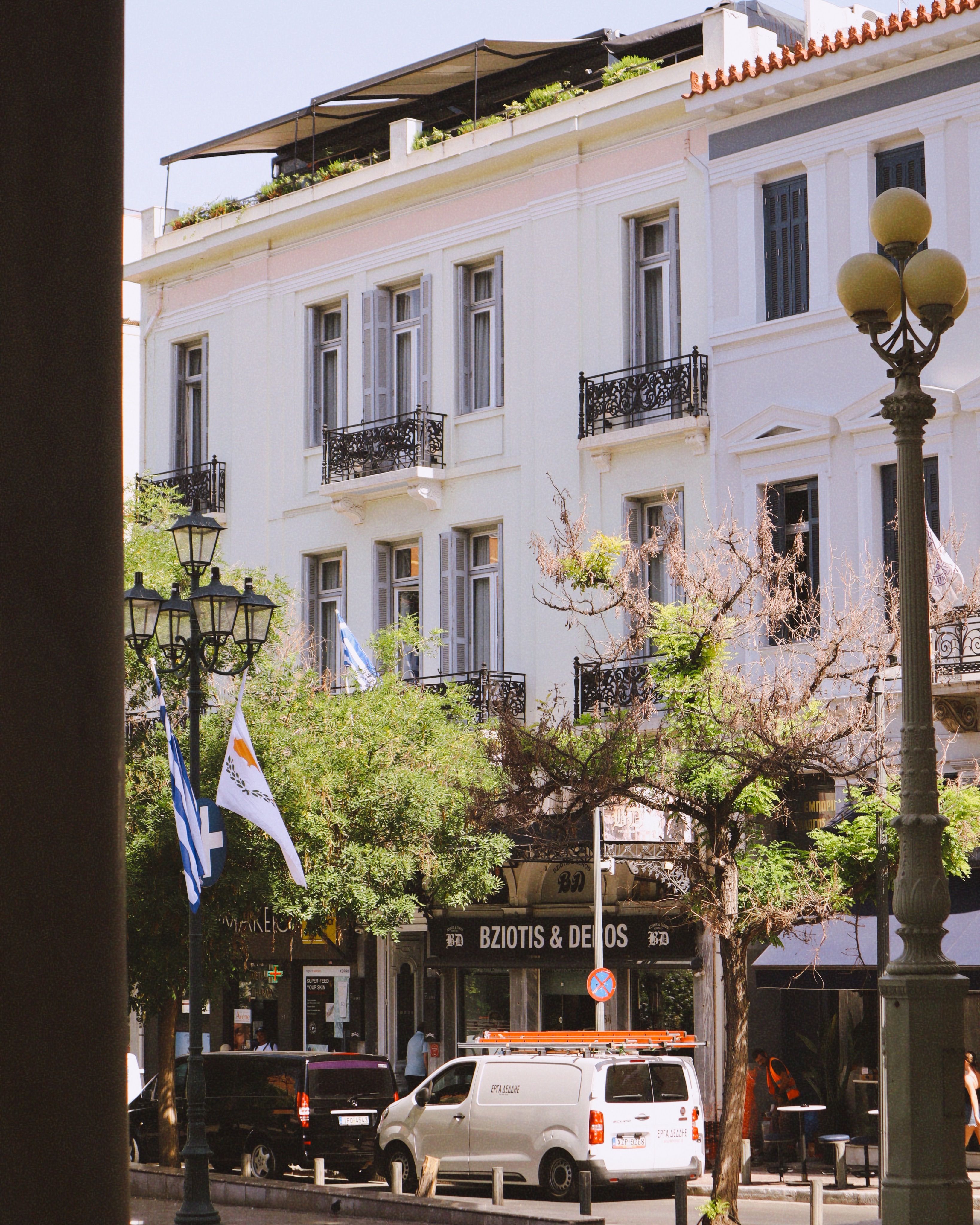 Elegant street scene capturing classic European building with balconies on a sunny day.
