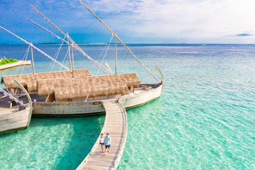 Photo Of People Walking On Wooden Footbridge