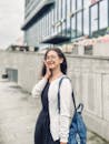 Smiling Young Woman with Backpack in Urban Setting