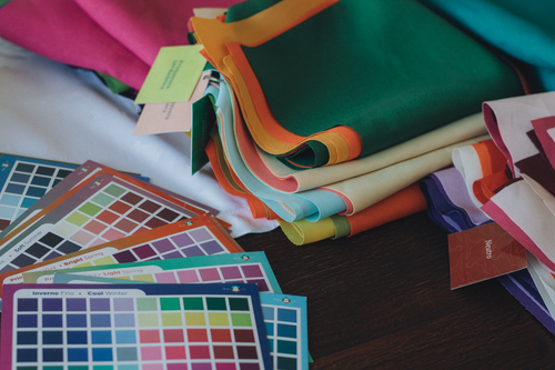 Free Pile of vibrant fabric swatches and color palettes for design and fashion projects. Stock Photo