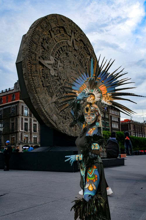 Free Person in Aztec outfit at Mexico City's iconic Stone of the Sun landmark. Stock Photo