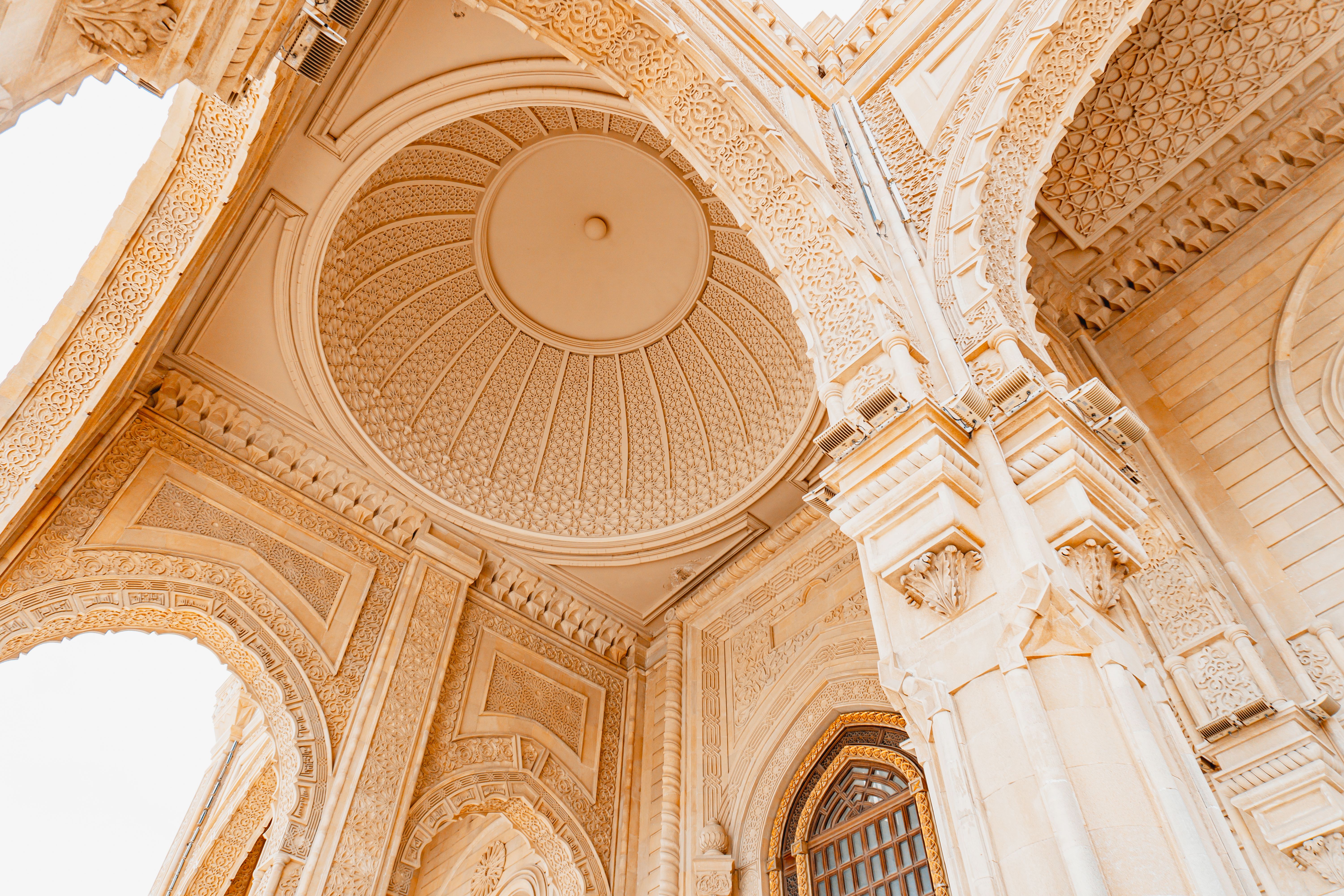 A detailed view of an ornate architectural dome and archway, showcasing exquisite craftsmanship.