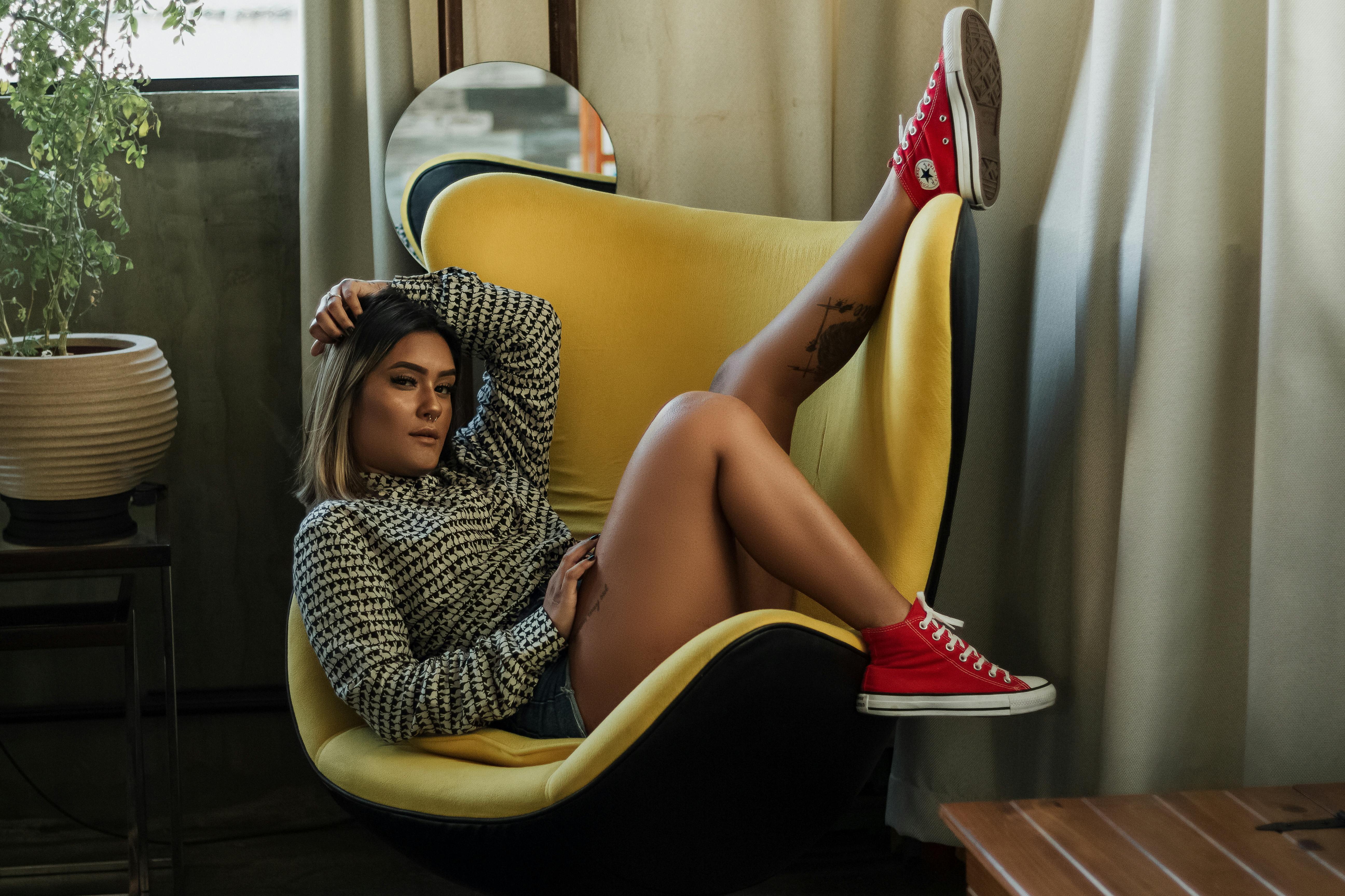 Photo Of Woman Sitting On Yellow Chair