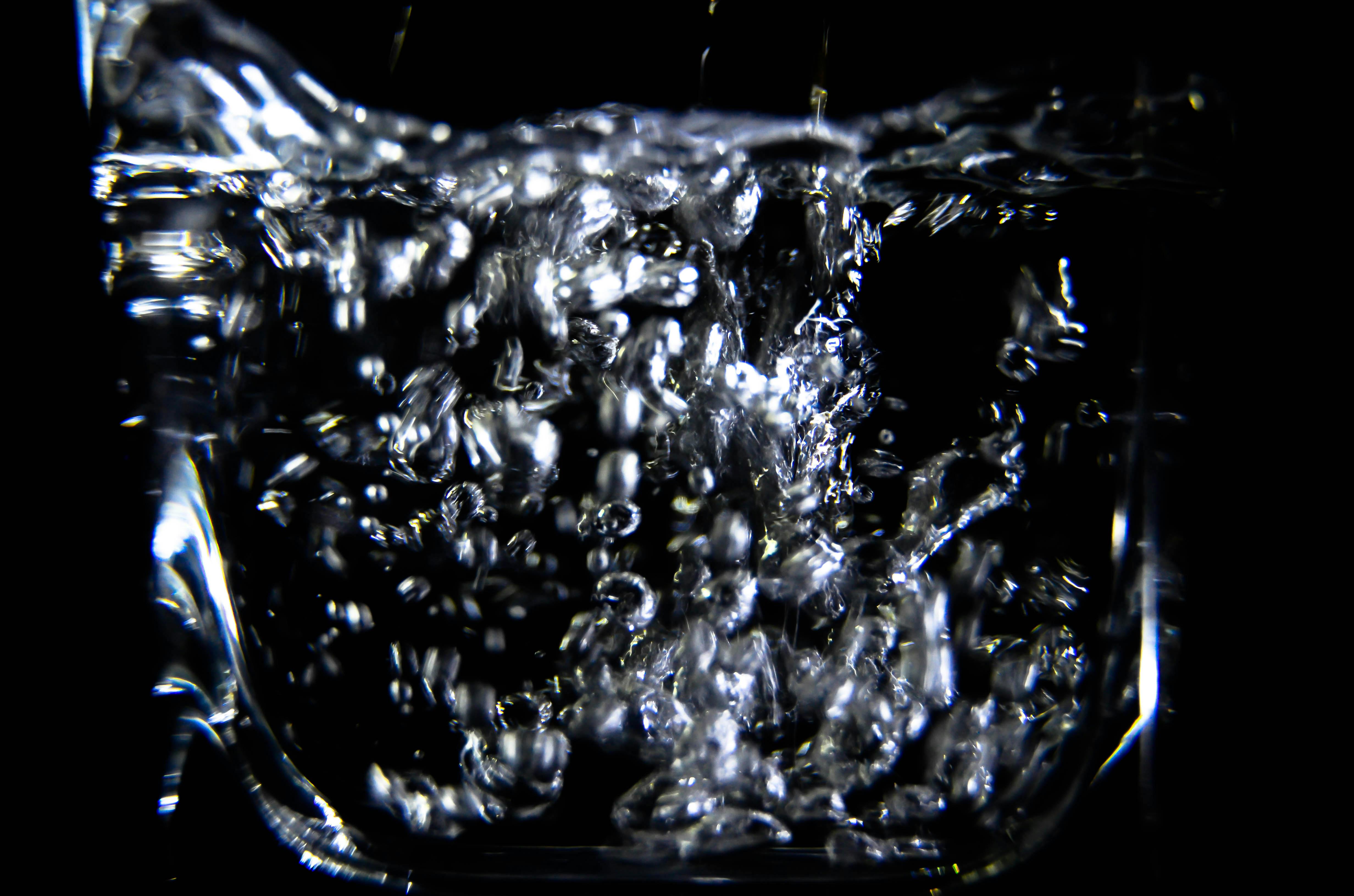 close up of water splashing against black background