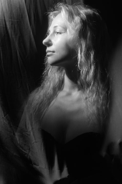 Free Striking black and white portrait of a woman with dramatic lighting, creating an ethereal feel. Stock Photo