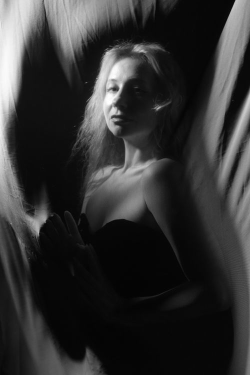 Free Elegant black and white portrait of a woman in artistic lighting, highlighting mystery and elegance. Stock Photo