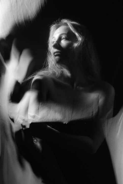 Free A dynamic black and white artistic portrait capturing a woman's graceful movement. Stock Photo