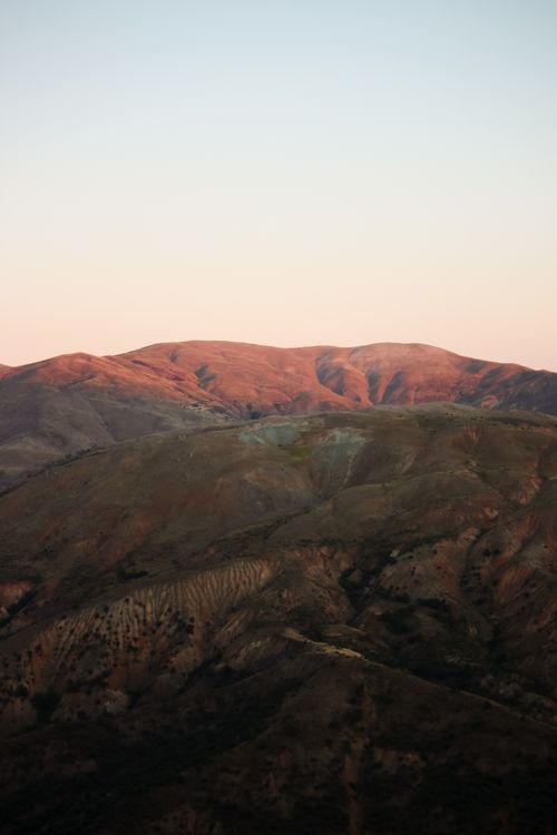 Free Beautiful sunrise over a tranquil mountain landscape with a clear sky. Stock Photo