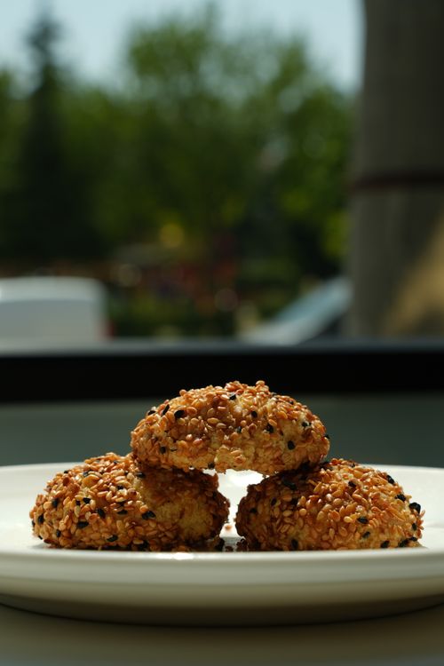 Free Delicious sesame seed cookies displayed on a white plate outdoors, perfect for snack time. Stock Photo