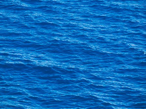 Free Beautiful blue ocean waves captured on a sunny summer day. Stock Photo