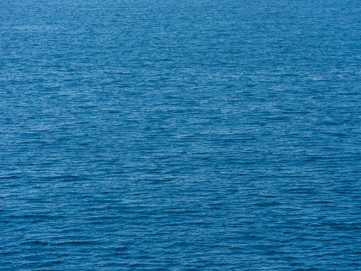 Tranquil Blue Ocean Waves Under Sunny Sky · Free Stock Photo