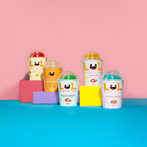 Free A vibrant and playful display of LOL bubble tea cups in various flavors on a colorful backdrop. Stock Photo