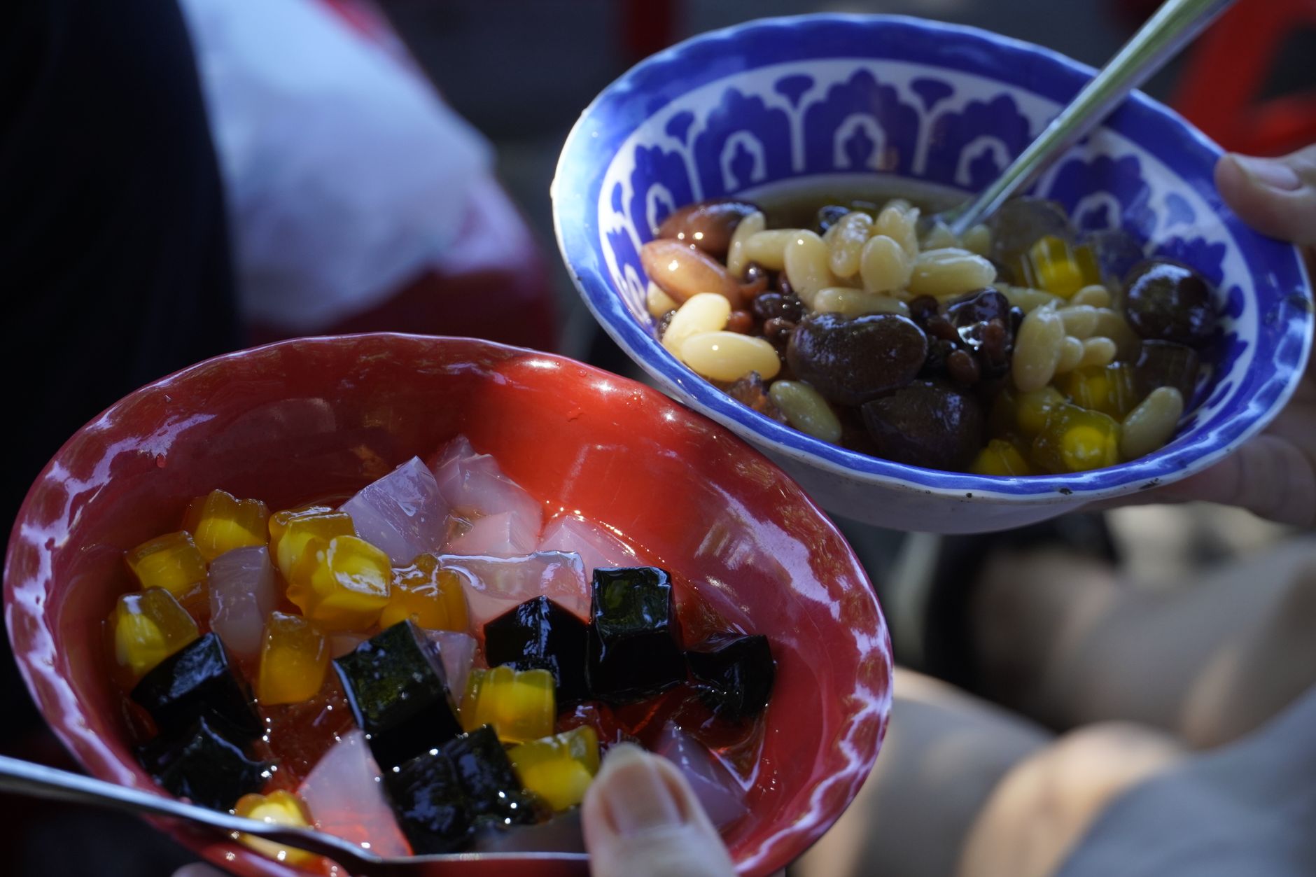 Colorful Vietnamese dessert bowls with chè in Hội An, Vietnam's vibrant culinary street scene.