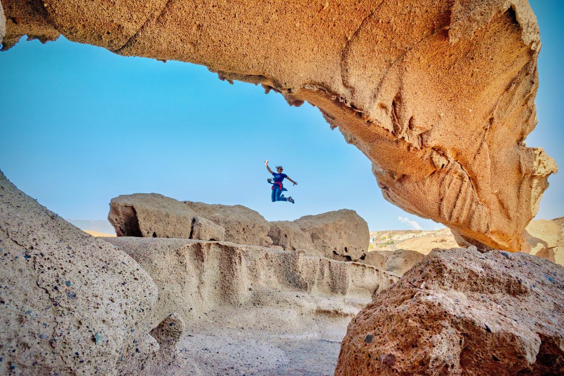 Person Jumping Amongst Unique Rock Formations · Free Stock Photo