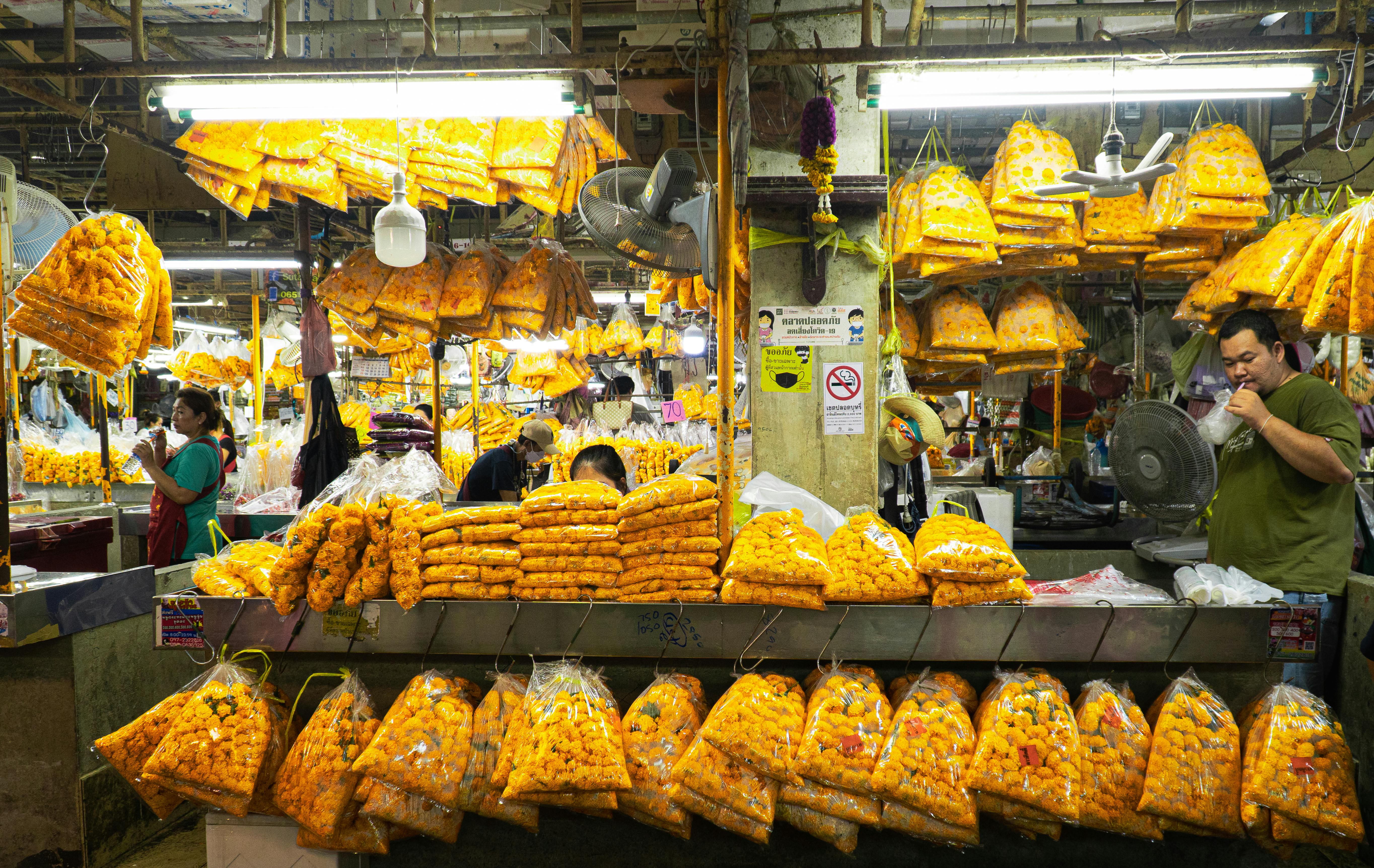 Experience the vibrant marigold flower market in Thailand filled with traditional offerings and local culture.