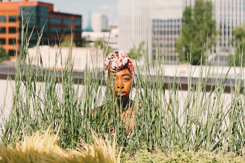 Photo Of Woman Sneaking Near Grass