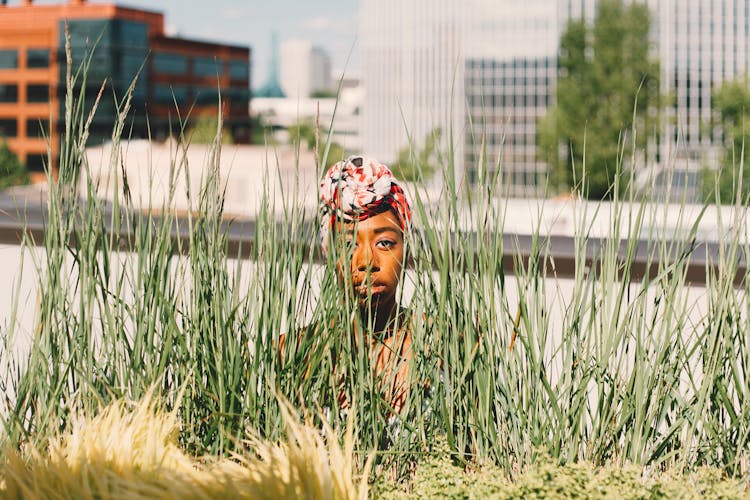 Photo Of Woman Sneaking Near Grass