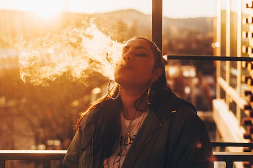 Photo Of Woman Playing With Smoke