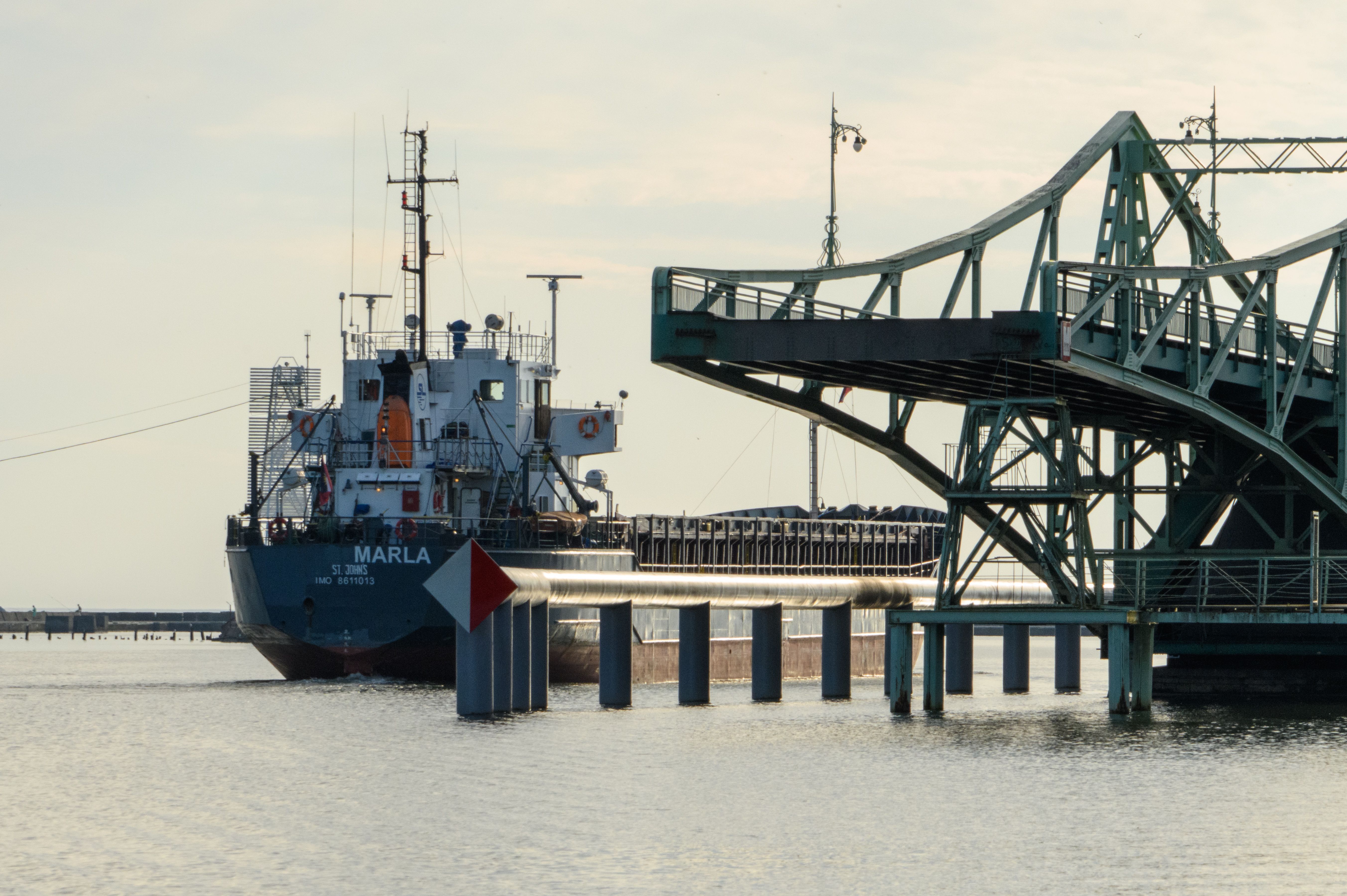Cargo Ship Passing Under Drawbridge at Sunset · Free Stock Photo