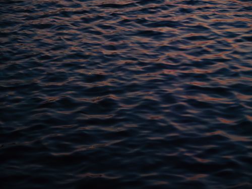 Free Gently rippling lake surface with sunset reflections in Sainte-Agathe-des-Monts, Quebec. Stock Photo
